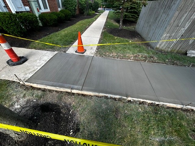 small section of sidewalk with fresh concrete